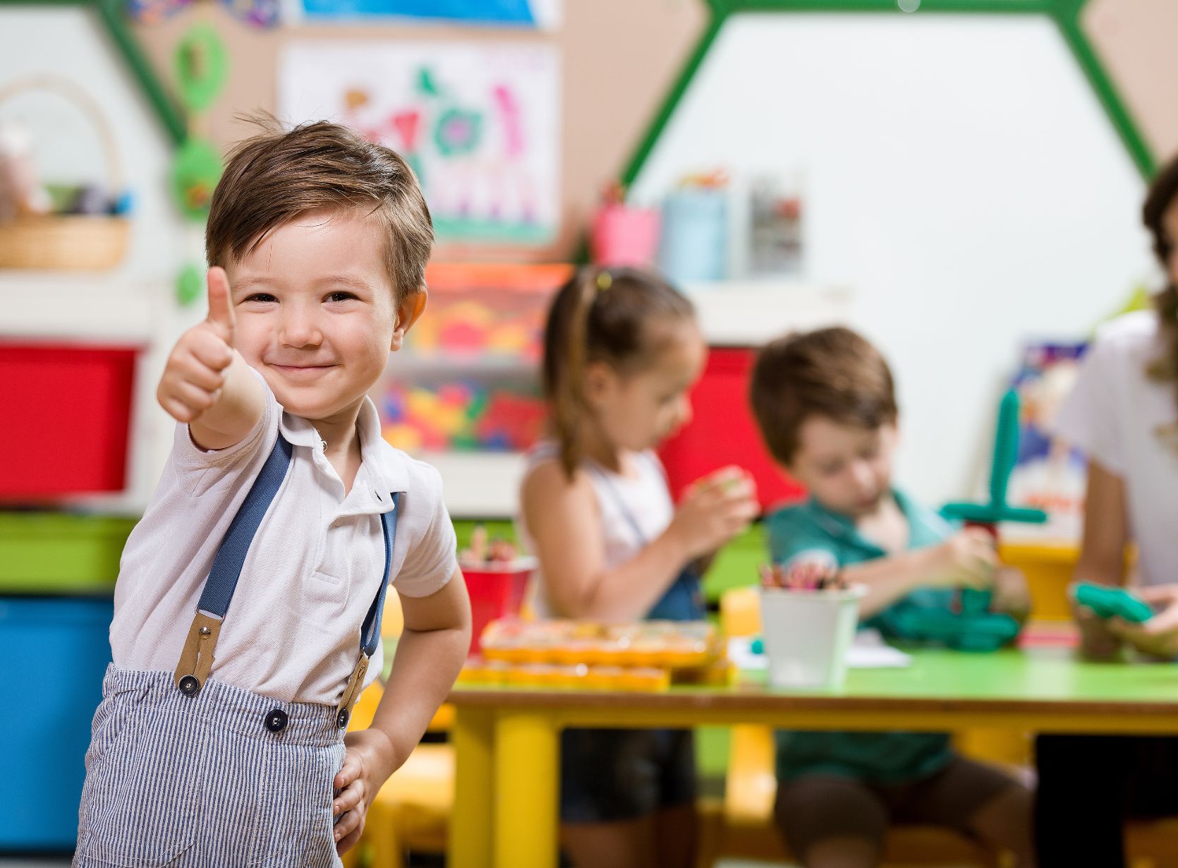 Happy child in preschool classroom.